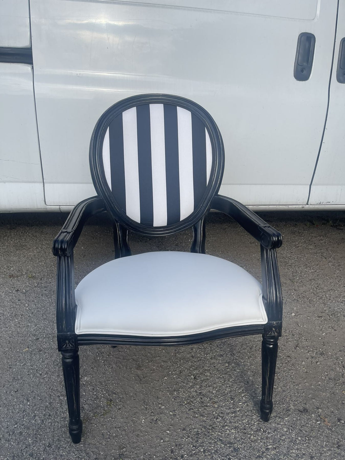 Black-frame dining chairs around round pedestal tables