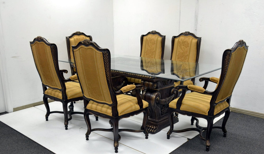 Carved pedestal dining table with gold-finish armchairs