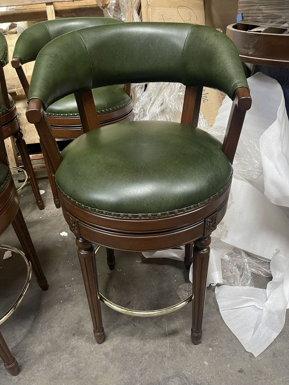Green leather swivel bar stools with nailhead trim