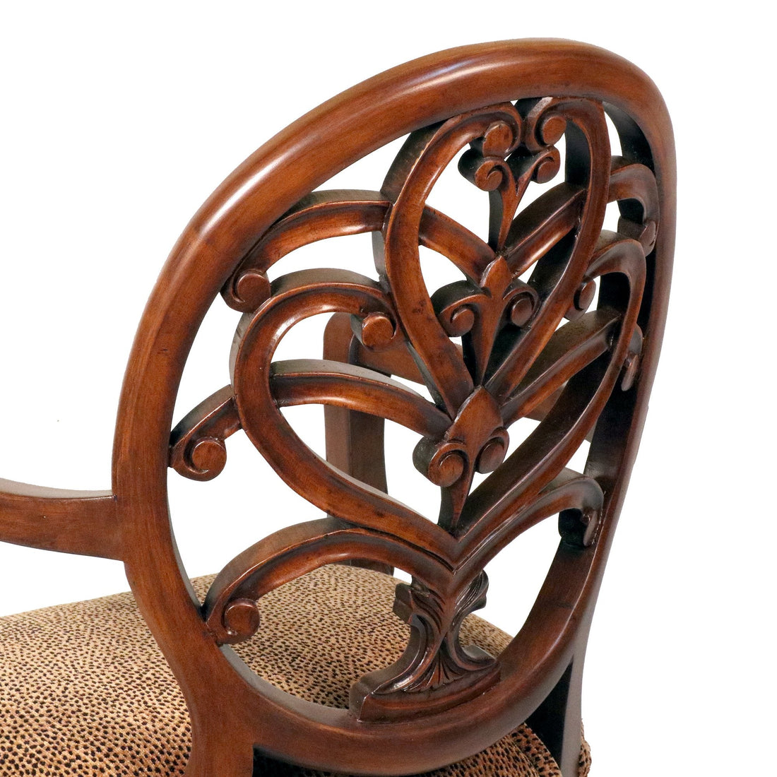 Close-up of a hand-carved walnut chair back with scrollwork