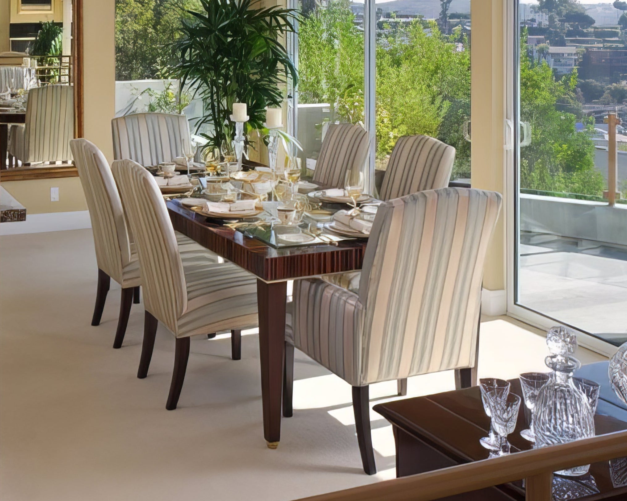 Dining room with a large window view, table set for dinner, and decorative elements.