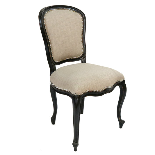 Beige upholstered chair with black frame on a white background