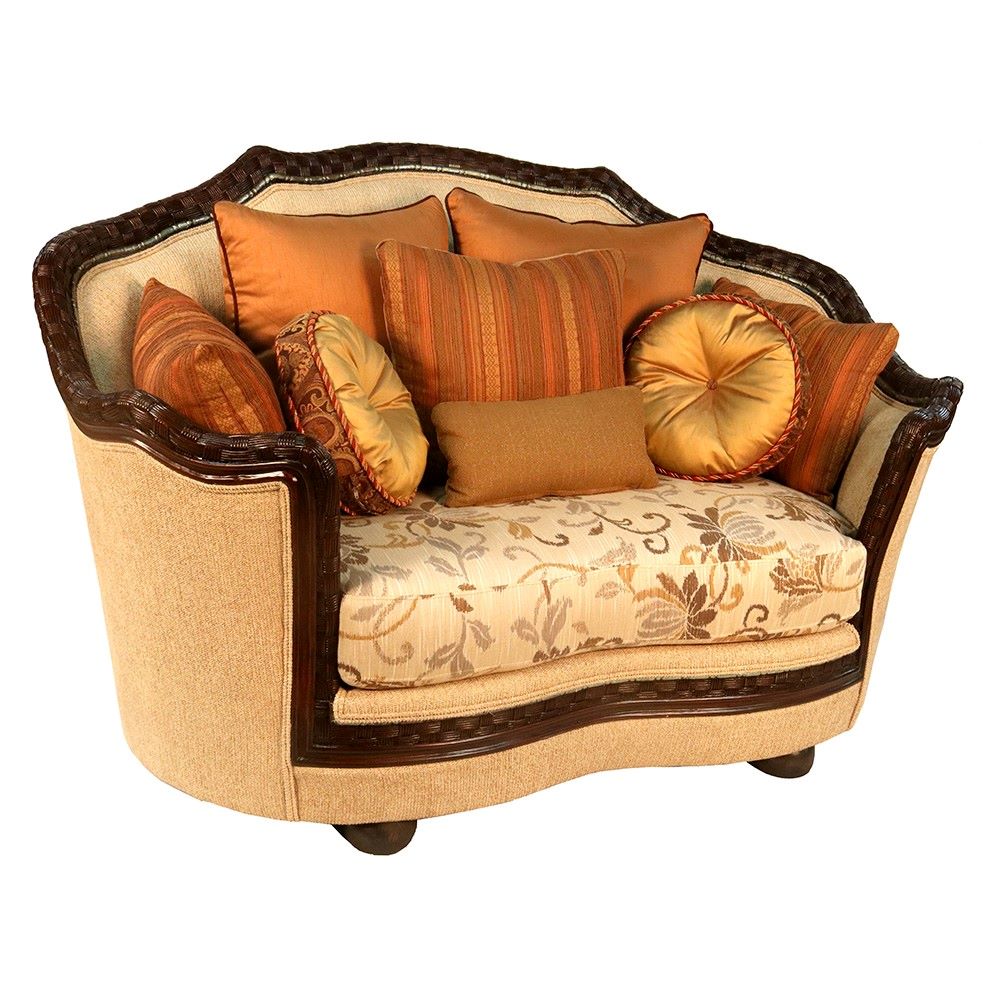 Decorative armchair with floral pattern and orange cushions on a white background